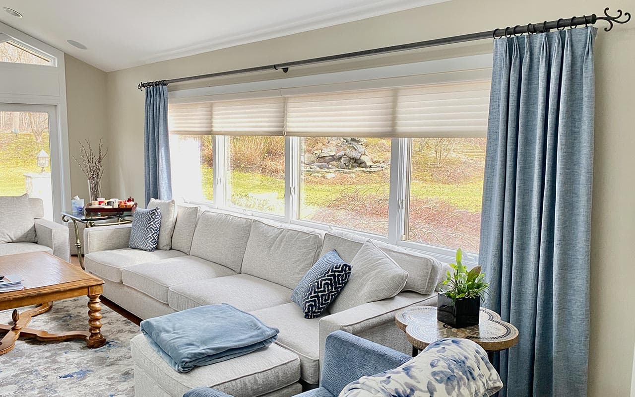Custom drapery and roman shades in a family living room
